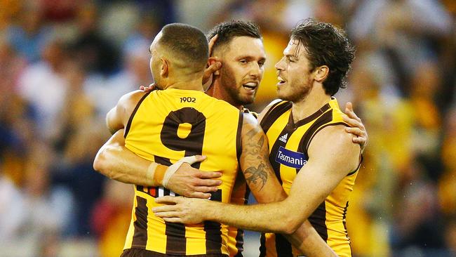 MELBOURNE, AUSTRALIA - MARCH 24: Shaun Burgoyne (L) Jack Gunston (C) and Isaac Smith of the Hawks celebrate a goal during the round one AFL match between the Hawthorn Hawks and the Collingwood Magpies at Melbourne Cricket Ground on March 24, 2018 in Melbourne, Australia. (Photo by Michael Dodge/Getty Images)