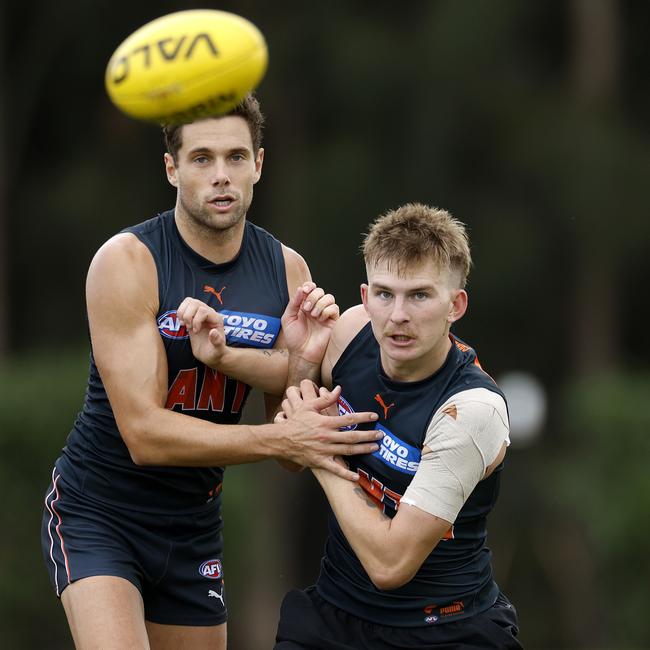 Josh Fahey (right) battles Josh Kelly at GWS training.