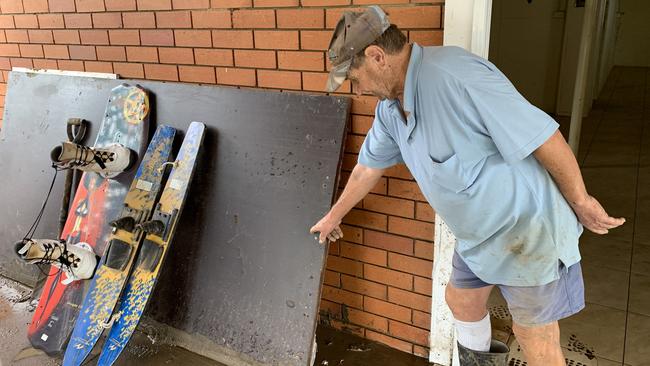 Kevin Dawson shows the board he'd used to partition off his home during the flood. Picture: Liana Walker