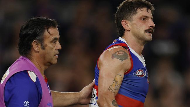 MELBOURNE , AUSTRALIA. April 12, 2024.  AFL. Round 5. Western Bulldogs vs Essendon at Marvel Stadium.   Bulldog Tom Liberatore in the hands of a trainer after being solidly tackled by Jake Stringer of the Bombers      . Pic: Michael Klein