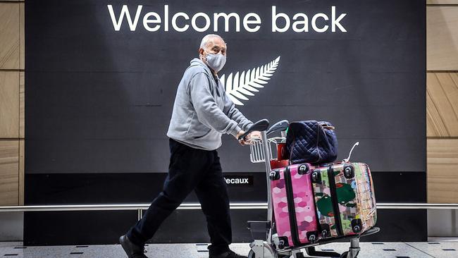 A passenger wearing a face mask arrives from New Zealand at Sydney International Airport. Picture: AFP