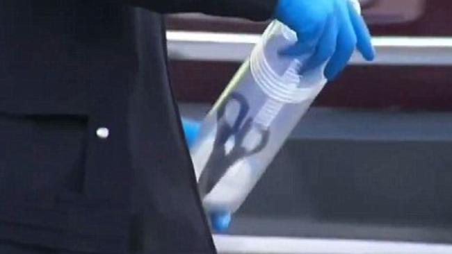 Police remove a pair of scissors from the crime scene. Picture: Nine News.