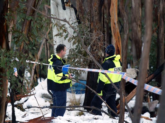 Police inspect wreckage from the Piper Chieftain near Mount Hotham following the crash which killed pilot Russell Lee, property developer Brian Ray and his wife Kathy.