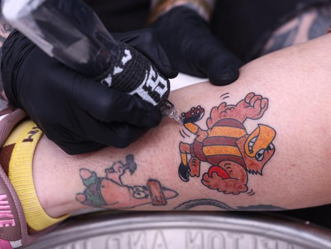 Footy finals fever has hit Thirsty Camel, the bottleshop  is celebrating the excitement of September with a free drive-thru tattoo parlour for fans who love to wear their favourite footy team on their sleeve.