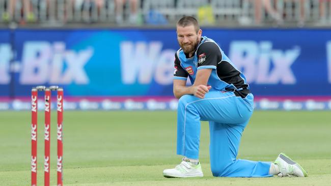 Michael Neser of the Strikers recovers after falling while bowling during the Big Bash League