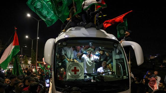 The crowd surrounds a bus carrying Palestinians released from Israeli jails. Picture: Ahmad Gharabli