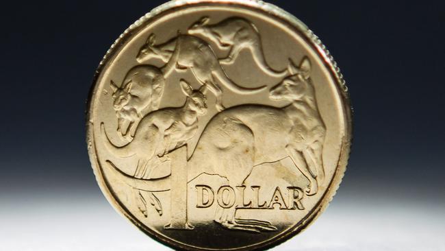 An Australian one-dollar coin is arranged for a photograph in Sydney, Australia, on Wednesday, April 17, 2013. Direct trading between the Australian dollar and yuan started on April 10. Photographer: Ian Waldie/Bloomberg