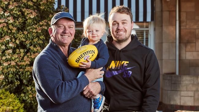 South Australian football legend Mark Naley, who has battled brain tumours, with grandson Finn and son Sam. Picture: Matt Loxton