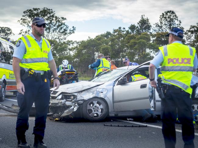 Narangba,Australia,July 25,2013: Car accident on the Bruce Highway in Queensland . An accdent when a car veered of the road and hit another car spinning it around,the image show attendance by both the  Queensland Ambulance service and the Queensland police force