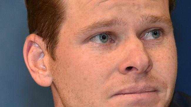 Steve Smith shows his emotion after being quizzed about sandpapergate at Sydney Airport on his arrival back from South Africa. Picture: PETER PARKS / AFP