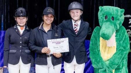 Team NT's Bridie McKenna, Lalwa May, Layne Martin, and mascot the Croc (Brooke Huppatz) after receiving the Sportsmanship Award at the 2023 Marcus Oldham Australian Interschool Championships. Picture: Vicki Martin.