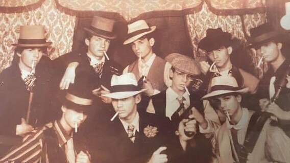 Vince Focarelli, pictured centre with glasses and beret-style cap, with friends at the Royal Show armed with Tommy guns.