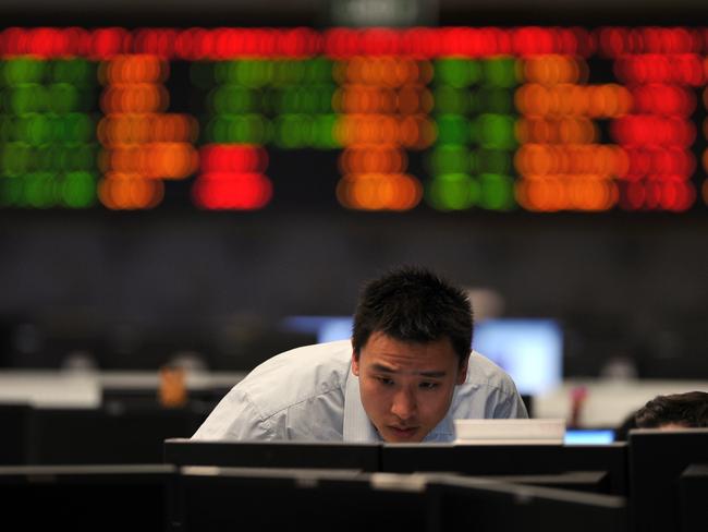 Analysts watch stock prices on the trading floor at the Westpac Bank in Sydney on Tuesday, Aug. 9, 2011. Carnage on overseas share markets spread to the local bourse on Tuesday, with Australia now considered a bear market amid a crisis in investor confidence and margin calls. (AAP Image/Paul Miller) NO ARCHIVING