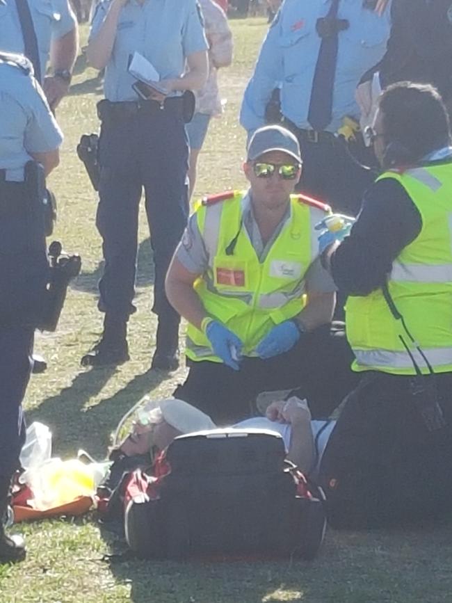 A man is attended to by paramedics at the music festival. Picture: Damian Shaw