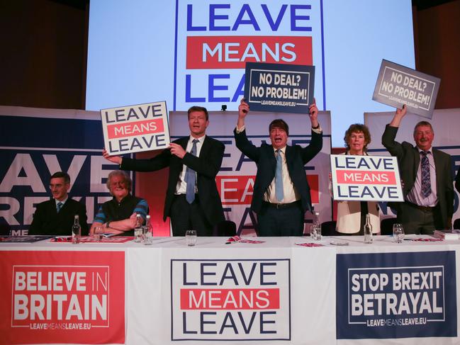 (L-) Participants Conservative MP Jacob Rees-Mog, Wetherspoons' Chairman Tim Martin, sit as Vice-chairman of the pro-Brexit Leave Means Leave group, Richard Tice, former UK Independence Party (UKIP) leader Nigel Farage, British Labour Party MP Kate Hoey, Democratic Unionist Party (DUP) Sammy Wilson and Chairman of the pro-Brexit Leave Means Leave group, John Longworth hold up signs with slogans at a political rally organised by the pro-Brexit Leave Means Leave campaign group in central London on December 14, 2018. - The Leave Means Leave group, supported by political figures like ERG chairman Jacob Rees-Mogg and former UKIP leader Nigel Farage, held a political rally to "Save Brexit" as the latest Brexit summit in Brussels leaves Theresa May facing a dwindling number of options over Britain's exit from the EU. The 27 leaders made abundantly clear to the British prime minister that the draft withdrawal agreement they reached after nearly two years of talks was not open to change. (Photo by Daniel LEAL-OLIVAS / AFP)