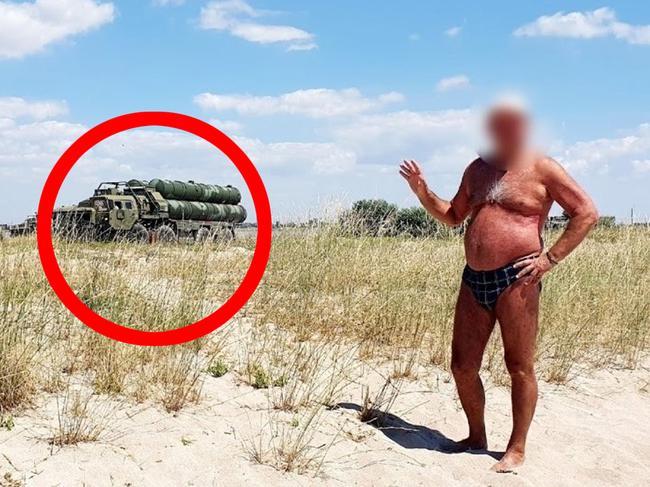 A Russian military vehicle in the background of the photo.