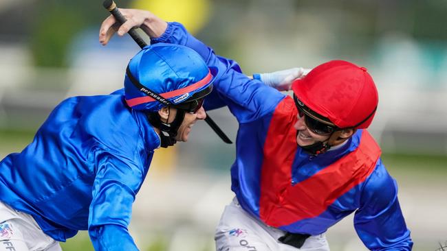 James McDonald celebrates winning the Paramount+ Mackinnon Stakes aboard Zaaki (GB) with runner up Brett Prebble at Flemington Racecourse on November 06, 2021 in Flemington, Australia. (Scott Barbour/Racing Photos via Getty Images)