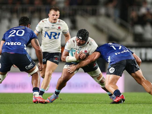 Waratahs' Tolu Latu (2nd R) is tackled by Blues' Jordan Lay. Picture: AFP