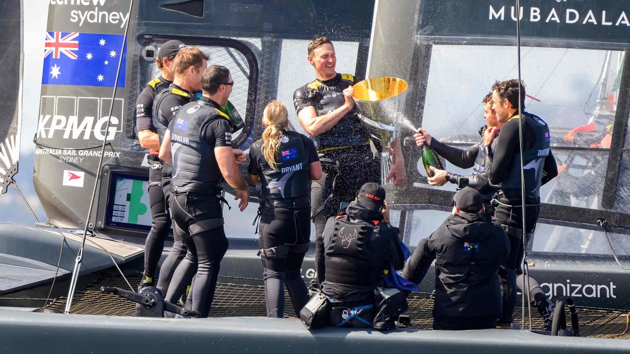 Australia SailGP Team with driver Tom Slingsby celebrates with Champagne and the trophy after winning the Mubadala SailGP Season 3 Grand Final in San Francisco, California, on May 7, 2023. (Photo by Josh Edelson / AFP)
