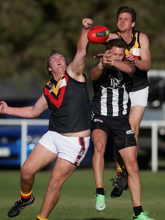 Todd Delahey climbs over a pack to spoil for Bacchus Marsh. 