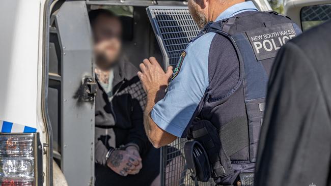 Police put Callaway in a police van on the way to charging him at the police station. Picture: NSW Police