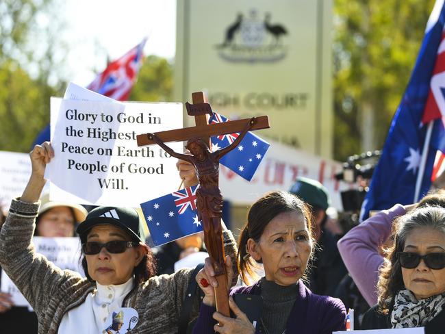 Supporters of George Pell pray outside the High Court of Australia in Canberra, Wednesday, March 11, 2020. The full bench of the High Court of Australia will today hear George Pell's final appeal. (AAP Image/Lukas Coch) NO ARCHIVING