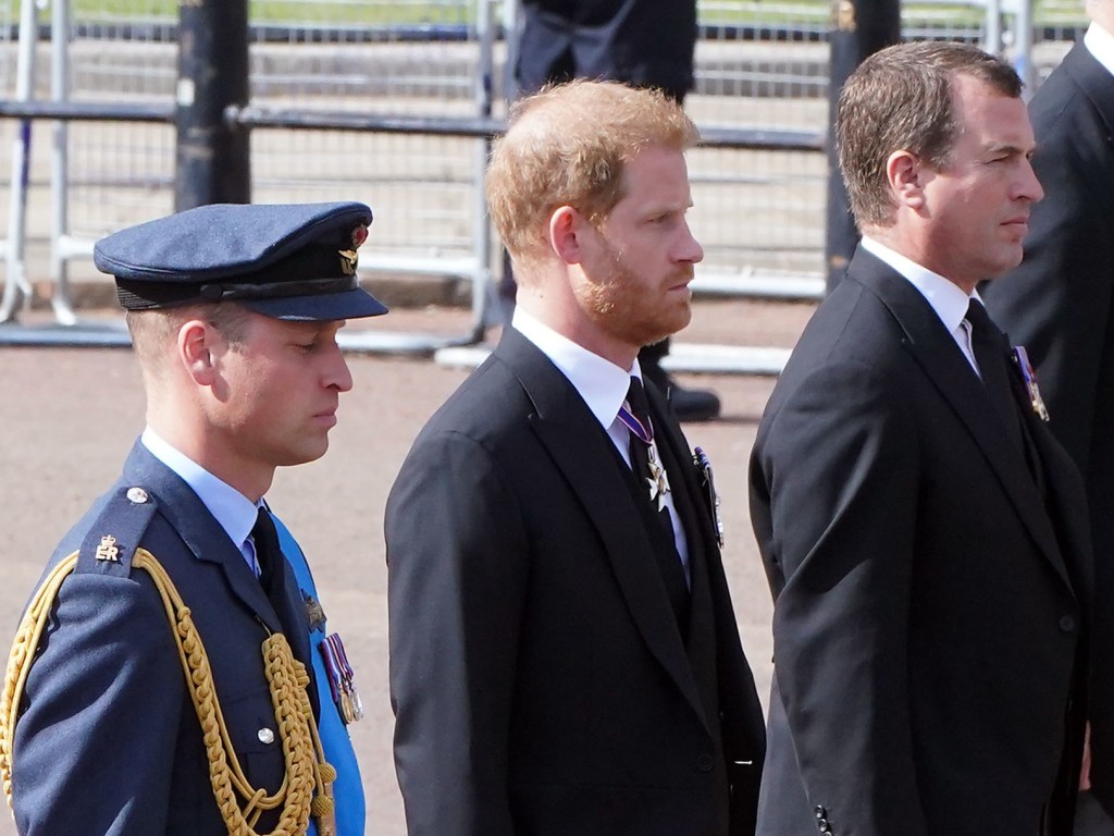 LONDON, ENGLAND - SEPTEMBER 14:   Prince William, Prince of Wales, Prince Harry, Duke of Sussex and Peter Phillips, walk behind the coffin during the ceremonial procession of the coffin of Queen Elizabeth II from Buckingham Palace to Westminster Hall on September 14, 2022 in London, United Kingdom. Queen Elizabeth II's coffin is taken in procession on a Gun Carriage of The King's Troop Royal Horse Artillery from Buckingham Palace to Westminster Hall where she will lay in state until the early morning of her funeral. Queen Elizabeth II died at Balmoral Castle in Scotland on September 8, 2022, and is succeeded by her eldest son, King Charles III. (Photo by Ian West - WPA Pool/Getty Images)