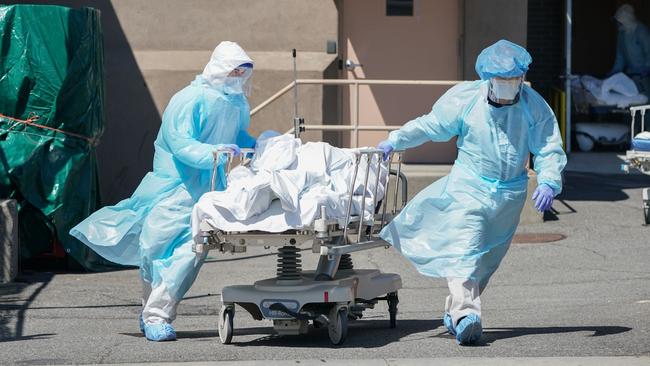 Bodies are moved to a refrigeration truck serving as a temporary morgue at a New York hospital in April. Picture: AFP