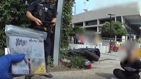Body-cam footage shows the moment police allegedly found $100,000 in the possession of the rider and his pillion passenger.