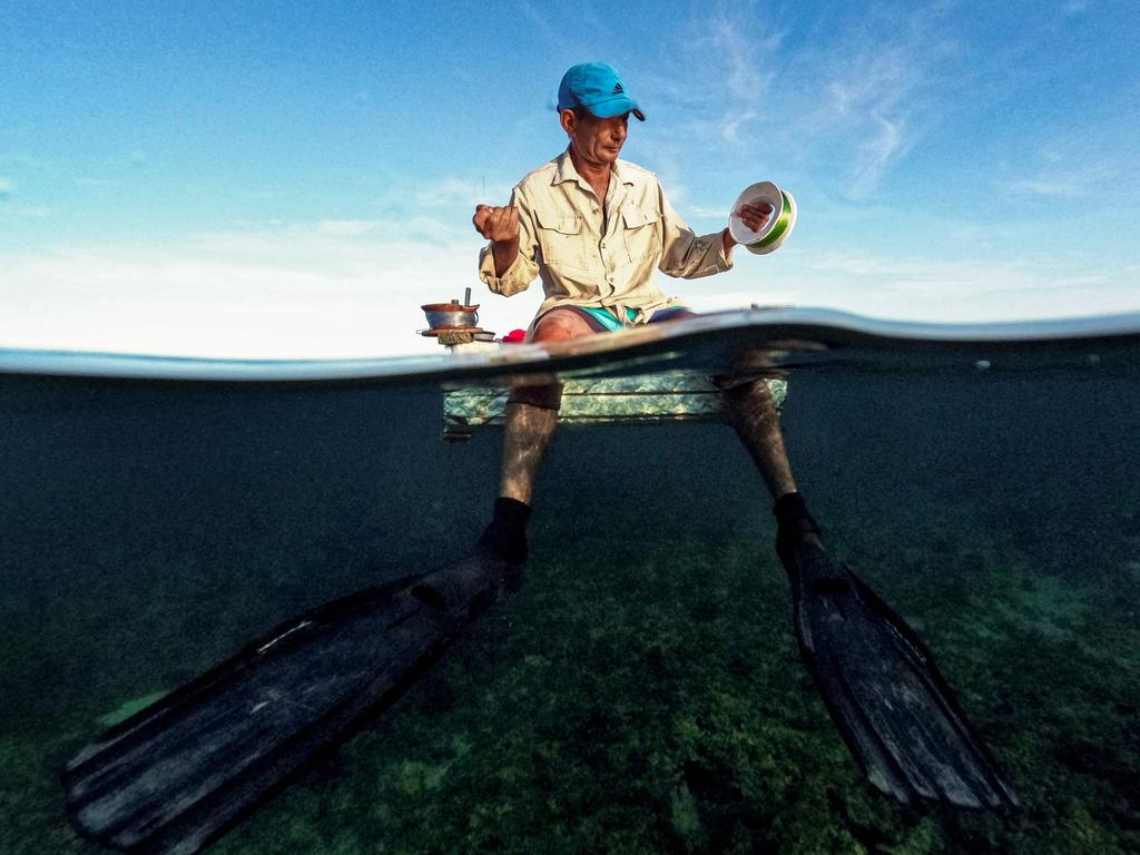 A Cuban fisherman prepares to fish on a makeshift raft in Havana Bay, on July 16, 2024.. When the weather permits, artisanal fishermen take to the water in improvised polystyrene rafts to make up for the lack of means and fuel. Picture: AFP