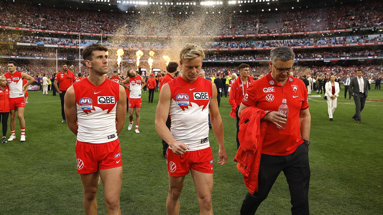 Isaac Heeney and teammates walk off the ground as the Lions celebrate. Photo by Phil Hillyard.