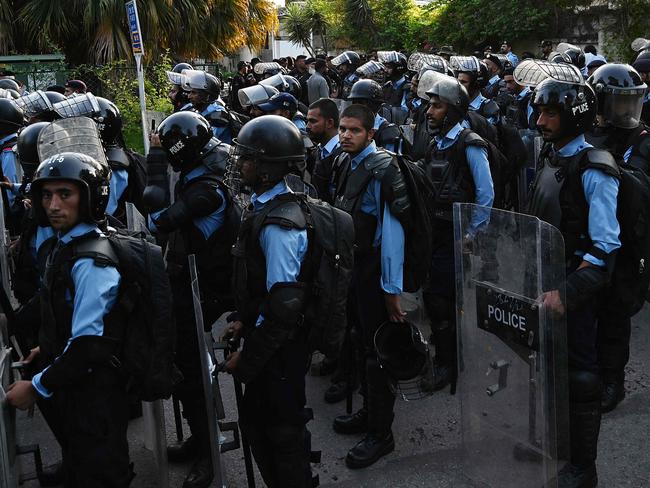 Riot polic cordon off a street as activists of right-wing religious Jamaat-e-Islami (JI) march toward the Sweden embassy during a demonstration in Islamabad on July 3, 2023, as they protest against the burning of the Koran outside a Stockholm mosque that outraged Muslims around the world. (Photo by Aamir QURESHI / AFP)