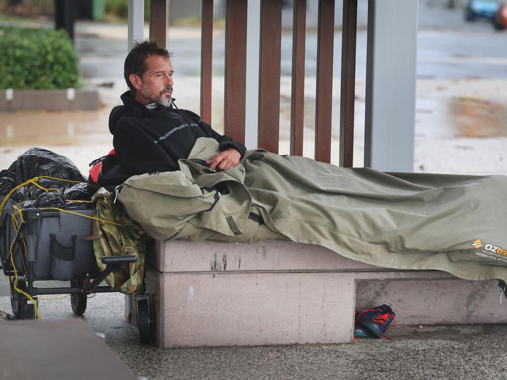 Homeless man Nico Jones shelters from the weather in his swag at Surfers Paradise. Picture Glenn Hampson