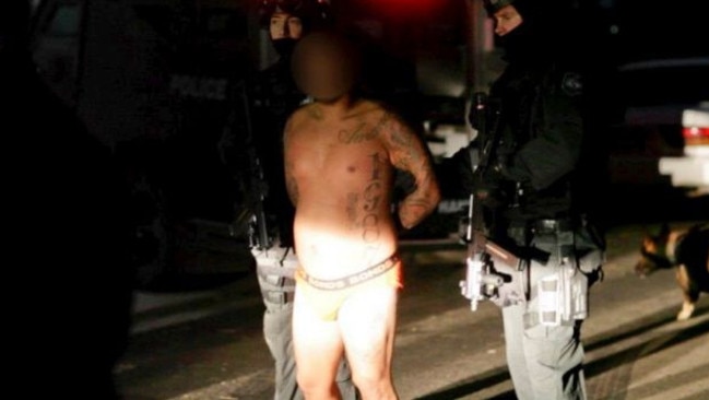 Kemel Barakat, pictured here under arrest in a police raid in 2013. Photo: NSW Police