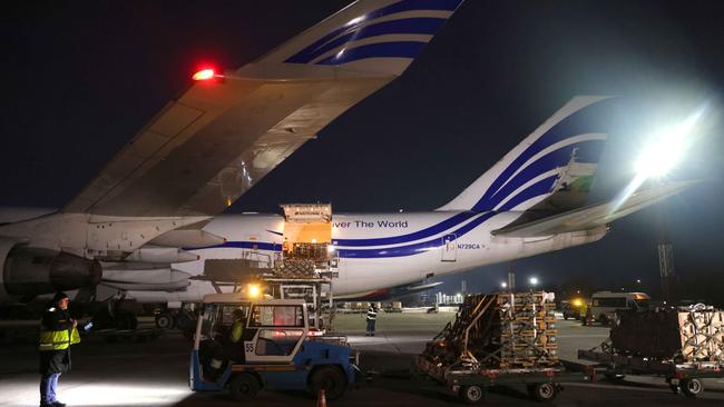 Ground crew unload weapons and other military hardware delivered by the US at Boryspil Airport near Kiev on Tuesday night. Picture: Getty Images