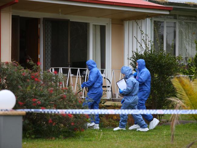 Forensic officers examine the house where the little girl was found yesterday. Picture: Phil Rogers