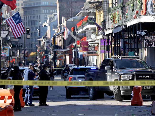 NEW ORLEANS, LOUISIANA - JANUARY 1: Law enforcement officers from multiple agencies work the scene on Bourbon Street after at least ten people were killed when a person allegedly drove into the crowd in the early morning hours of New Year's Day on January 1, 2025 in New Orleans, Louisiana. Dozens more were injured after a suspect in a rented pickup truck allegedly drove around barricades and through a crowd of New Year's revelers on Bourbon Street. The suspect then got out of the car, opened fire on police officers, and was subsequently killed by law enforcement.   Michael DeMocker/Getty Images/AFP (Photo by Michael DeMocker / GETTY IMAGES NORTH AMERICA / Getty Images via AFP)