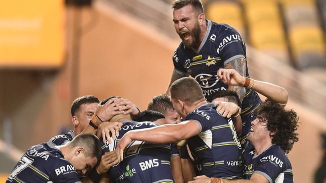 The Cowboys celebrate after running over the top of the Newcastle Knights at QCB Stadium.