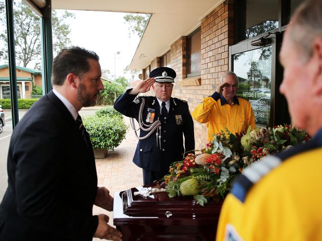 NSW RFS Commissioner Shane Fitzsimmons, with members of the RFS, show their respect to off-duty firefighter Colin Burns who was farewelled at an emotional funeral today. Picture: Tim Hunter.