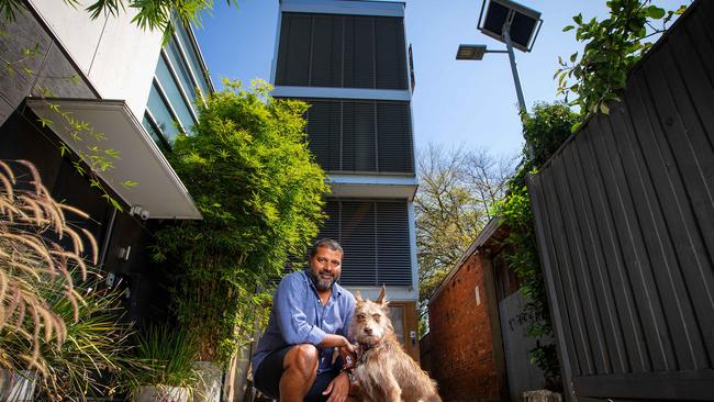 Ralph Alphonso and his dog, Rani, at his East Melbourne "mini skyscraper", which has been named among Australia’s Grandest Designs. Picture: Mark Stewart