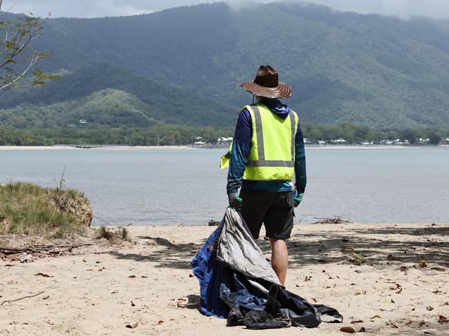 Businessman Audrius Macernis has purchased Taylor Point, the northmost parcel of land at Trinity Beach, for an undisclosed sum. The environmentalist plans to work with other conservation groups through his own organisation, the Macernis Group, to restore the landscape and bring Taylor Point back to its natural state. Taylor Point owner Audrius Macernis dismantles a tent that was set up on the headland by squatters. Picture: Brendan Radke