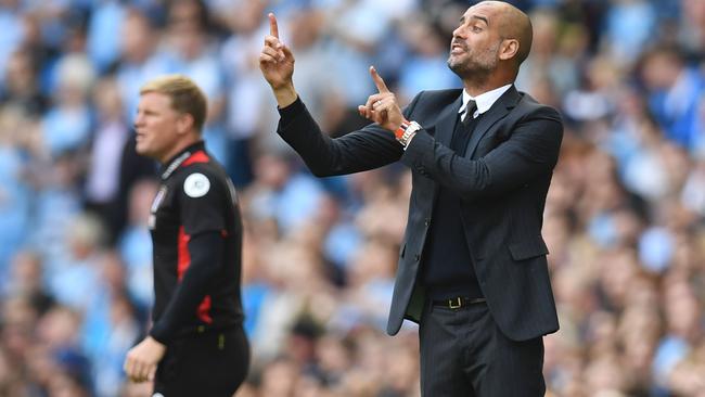 Manchester City's Spanish manager Pep Guardiola (R) gestures on the touchline next to Bournemouth's English manager Eddie Howe (L) during the English Premier League football match between Manchester City and Bournemouth at the Etihad Stadium in Manchester, north west England, on September 17, 2016. / AFP PHOTO / PAUL ELLIS / RESTRICTED TO EDITORIAL USE. No use with unauthorized audio, video, data, fixture lists, club/league logos or 'live' services. Online in-match use limited to 75 images, no video emulation. No use in betting, games or single club/league/player publications. /