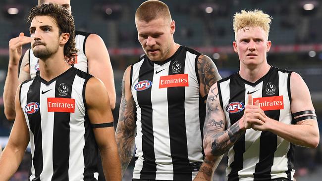 MELBOURNE, AUSTRALIA - MARCH 19: The Magpies look dejected after losing the round one AFL match between the Collingwood Magpies and the Western Bulldogs at Melbourne Cricket Ground on March 19, 2021 in Melbourne, Australia. (Photo by Quinn Rooney/Getty Images)