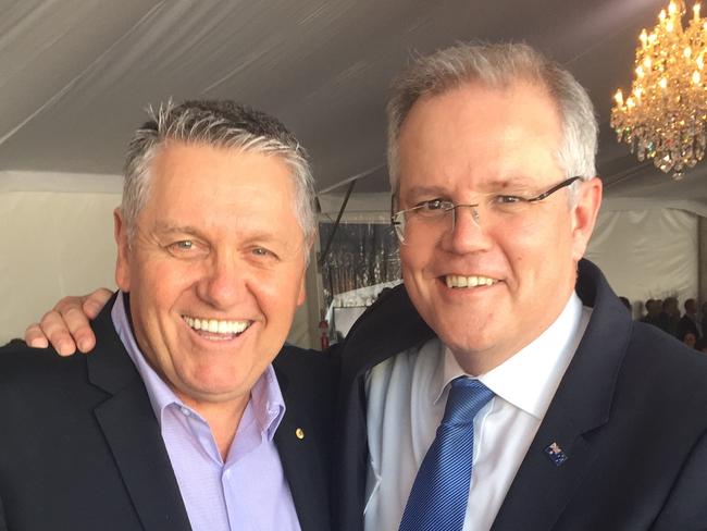 Ray Hadley and Scott Morrison with a bible auctioned for $10,000 at Glenn Wheeler fundraiser in Sydney