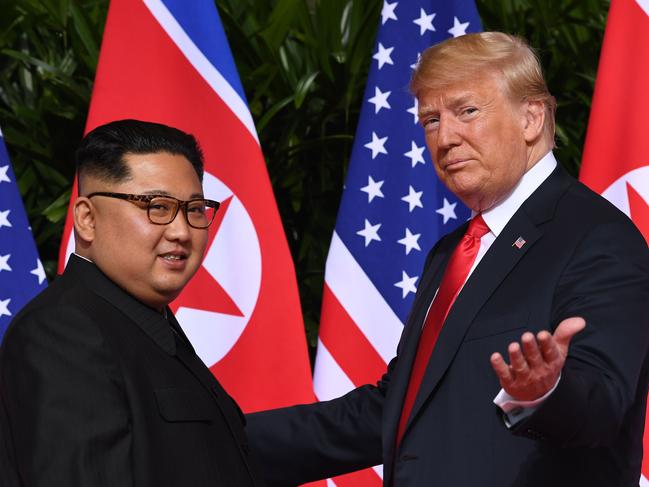 AFP presents a retrospective photo package of 60 pictures marking the 4-year presidency of President Trump.  US President Donald Trump (R) gestures as he meets with North Korea's leader Kim Jong Un (L) at the start of their historic US-North Korea summit, at the Capella Hotel on Sentosa island in Singapore on June 12, 2018. - Donald Trump and Kim Jong Un have become on June 12 the first sitting US and North Korean leaders to meet, shake hands and negotiate to end a decades-old nuclear stand-off. (Photo by SAUL LOEB / AFP)