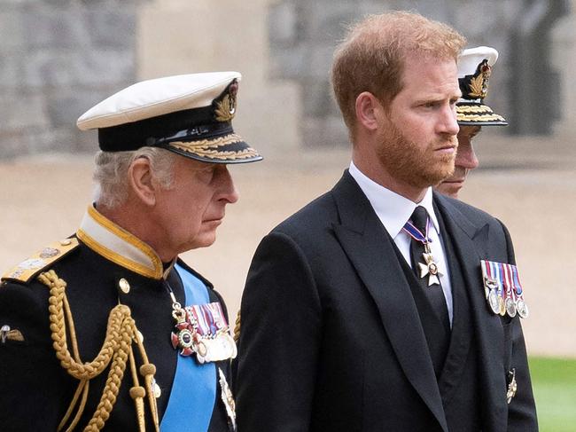 Britain's King Charles III (L) walks with his son Britain's Prince Harry, Duke of Sussex as they arrive at St George's Chapel inside Windsor Castle on September 19, 2022, ahead of the Committal Service for Britain's Queen Elizabeth II. - Monday's committal service is expected to be attended by at least 800 people, most of whom will not have been at the earlier State Funeral at Westminster Abbey. (Photo by David Rose / POOL / AFP)