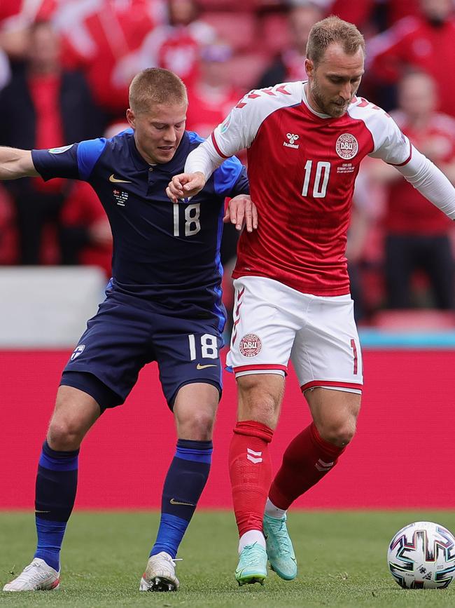 Christian Eriksen of Denmark (right) battles for possession with Jere Uronen of Finland before his collapse. Picture: Getty Images