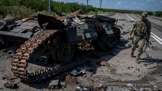 A Ukrainian soldier walks past a destroyed Ukrainian tank near Robotyne. Picture: Reuters