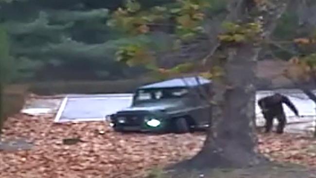 TOPSHOT — This screengrab made from video footage released by the United Nations Command on November 22, 2017 shows a North Korea defector running out from a vehicle at the Joint Security Area of the Demilitarised Zone (DMZ). Dramatic footage of a North Korean soldier's defection released on November 22 showed him racing across the border under fire from former comrades, and then being hauled to safety by South Korean troops. Picture: AFP