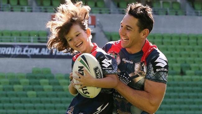 Slater and son Jake, 6, wear the Storm’s Thor jersey. Photo: Wayne Ludbey